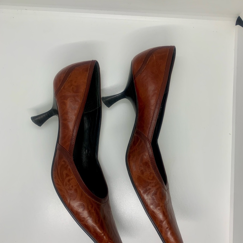 Cognac brown with faint swirl design. Shapely kitten heel.